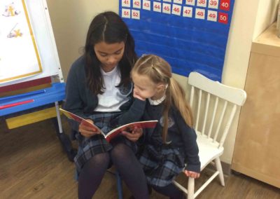 Buddies - Older grade student reading to Junior Kindergarten (JK) student at Westminster Classical Christian Academy (WCCA)