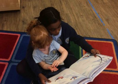 Buddies - older grade student reading to Kindergarten student at Westminster Classical Christian Academy (WCCA)