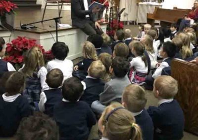 Principal reads to students during Chapel time